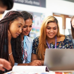 Four female students looking at a laptop - Join Study